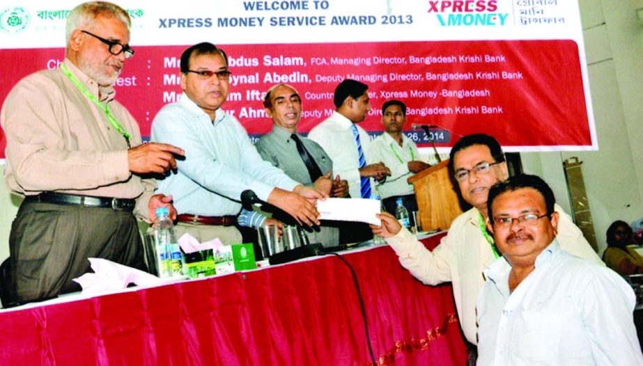 Managing Director of Bangladesh Krishi Bank Md Abdus Salam handing over prizes among the "Xpress Money Service Award-2013"" winners jointly organized by BKB and Xpress Money in the city on Saturday."