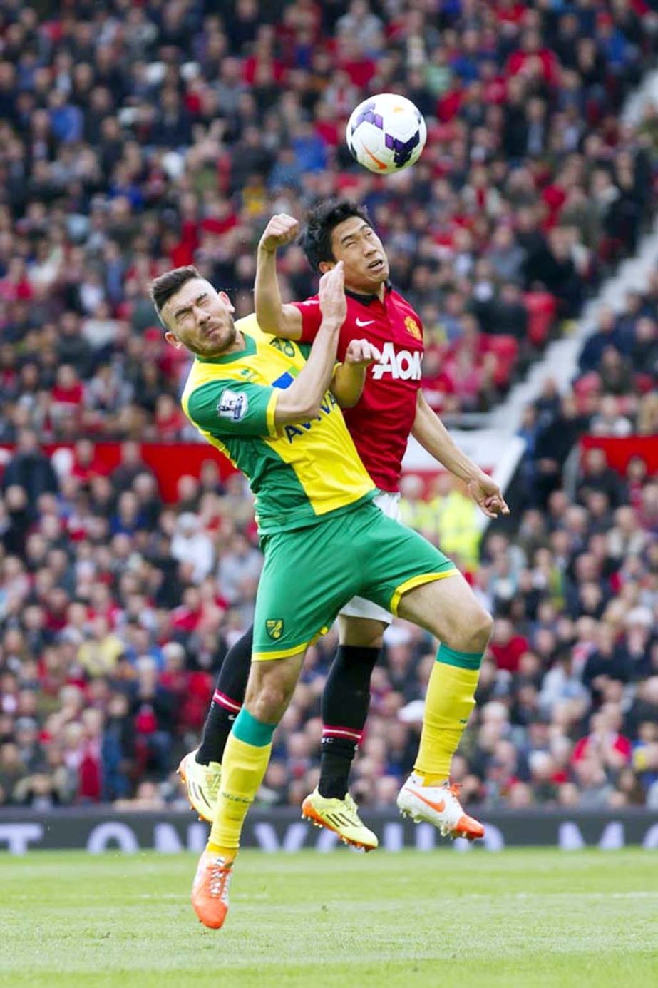 Manchester United's Shinji Kagawa (right) fights for the ball against Norwich City's Robert Snodgrass during their English Premier League soccer match at Old Trafford Stadium, Manchester, England on Saturday.