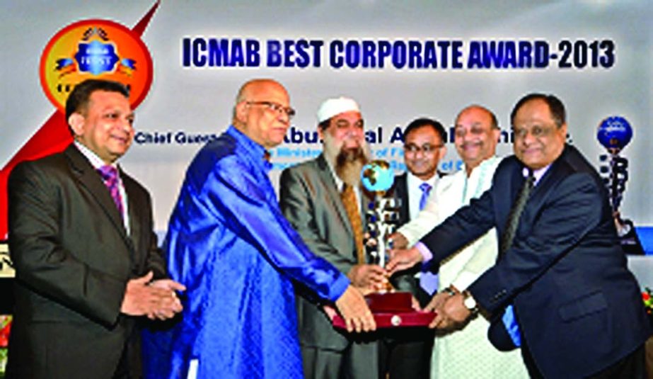 Finance Minister Abul Maal Abdul Muhith handing over the best corporate award -2013 by Institute of Cost and Management Accounts of Bangladesh to Rupali Bank's Chairman Dr Ahmed-al Kabir and Managing Director M Farid Uddin at a city hotel on Sunday. ICMA