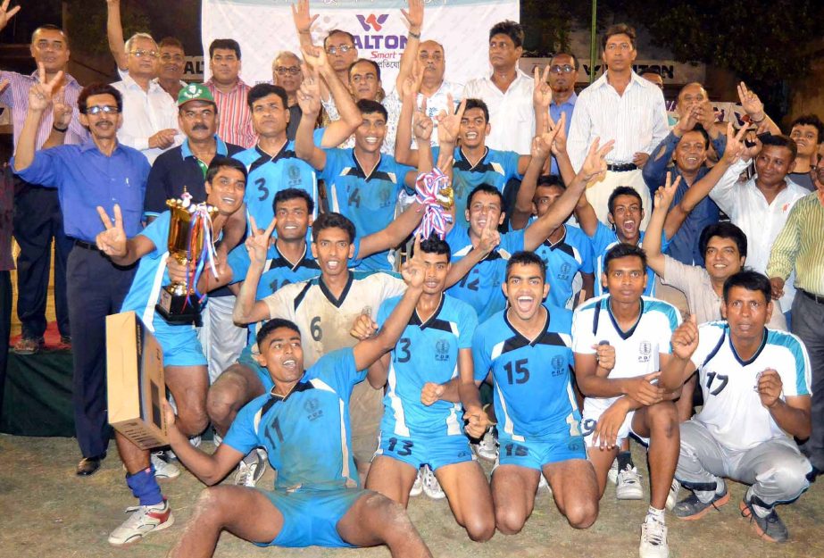 PDB SC, the champions of the Men's Division of the Walton Smart Television National Volleyball Competition and the officials of Bangladesh Volleyball Federation pose for a photograph at the Volleyball Stadium on Monday.