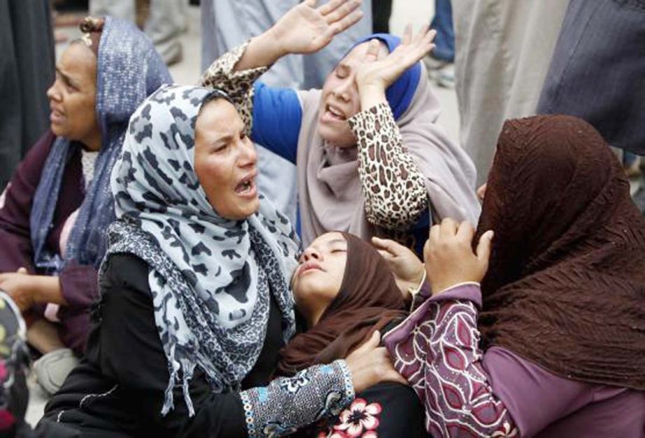 Relatives and families of members of Muslim Brotherhood and supporters of ousted President Mohamed Mursi react after hearing the sentence, in front of the court in Minya, south of Cairo .