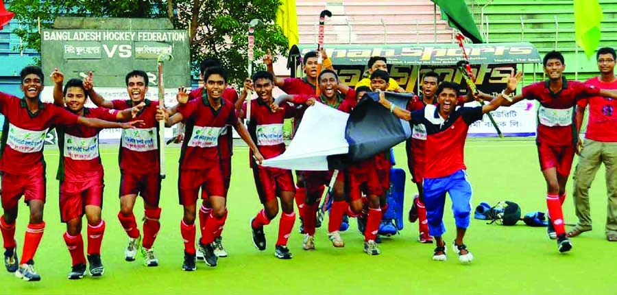 Players of Al Hima Muslim Academy , the champions of the First Security Islami Bank Limited National School Hockey Tournament celebrate after beating Jessore Municipal Preparatory School at the Moulana Bhashani National Hockey Stadium on Tuesday.