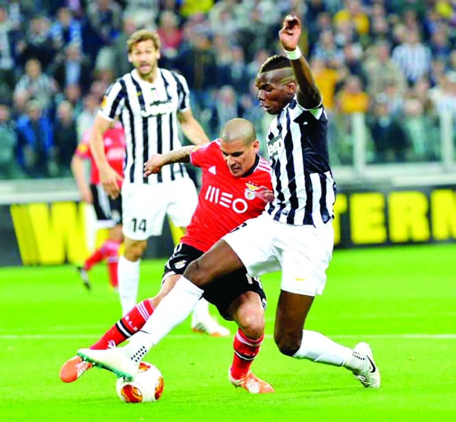 Juventus midfielder Paul Pogba of France (right) challenges for the ball with Benfica defender Maxi Pereira during the Europa League semifinal second leg soccer match between Juventus and Benfica at the Juventus stadium, in Turin, Italy on Thursday.