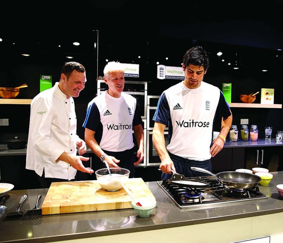 Peter Moores (c)and Alastair Cook prepare breakfast in London on Thursday.