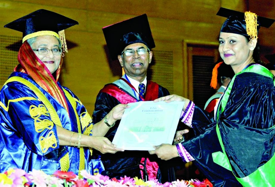 Prime Minister Sheikh Hasina distributing certificates among the students at the Convocation of Bangladesh College of Physicians and Surgeons at Bangabandhu International Conference Center in the city on Sunday. BSS photo