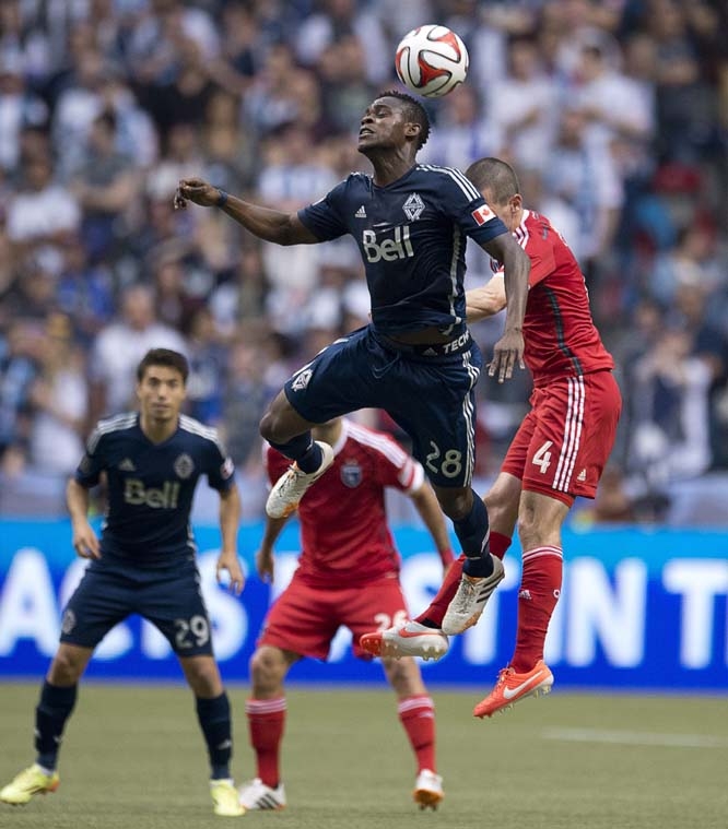 Vancouver Whitecaps' Gershon Koffie (28) fights for control of the ball with San Jose Earthquakes' Sam Cronin (4) during second-half MLS soccer game action in Vancouver, British Columbia on Saturday.