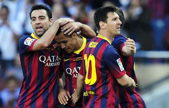 FC Barcelona's Alexis Sanchez (second left) celebrates after scoring against Getafe with his teammates Xavi Hernandez (left) and Lionel Messi from Argentina during a Spanish La Liga soccer match at the Camp Nou stadium in Barcelona, Spain on Saturday.