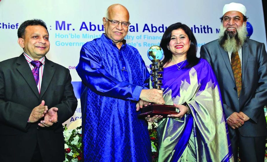Minister Finance Abul Maal Abdul Muhith handing over ICMAB Best Corporate Award 2013 in non-life/general insurance category to Managing Director and CEO of Green Delta Insurance Company Limited Farzana Chowdhury at a city hotel recently.