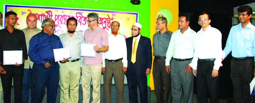 Lucky winners of Dhaka-Katmandu-Dhaka air tickets from "Boishakhi Offer"" programme at Saad Musa City Center seen with Group Managing Director Muhammad Mohsin at a function in the city on Monday."