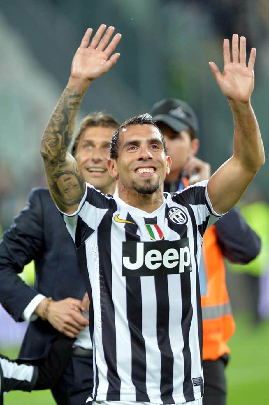 Juventus' Carlos Tevez celebrates at the end of a Serie A soccer match againsts Atalanta at the Juventus stadium in Turin Italy. Juventus clinched its third straight and 30th overall Serie A title on Monday.