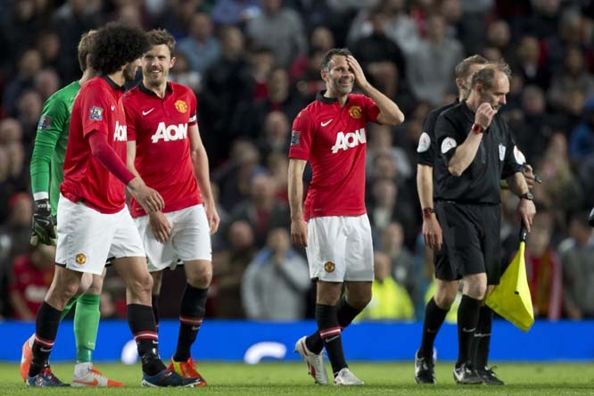 Manchester United's interim manager Ryan Giggs (centre right) smiles after his team's English Premier League soccer match against Hull City at Old Trafford Stadium, Manchester, England on Tuesday.