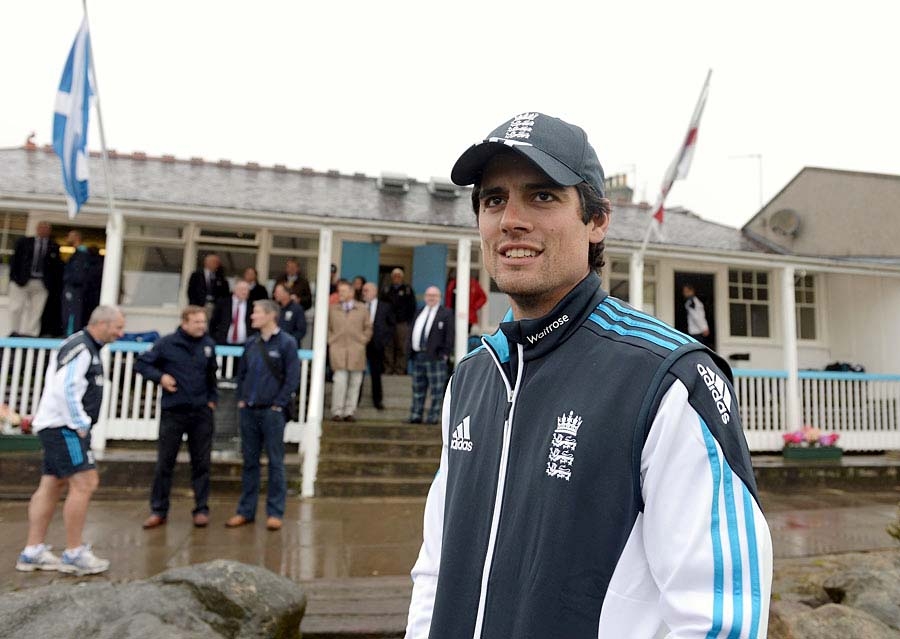 Alastair Cook surveys the soggy scene at Aberdeen on Friday.