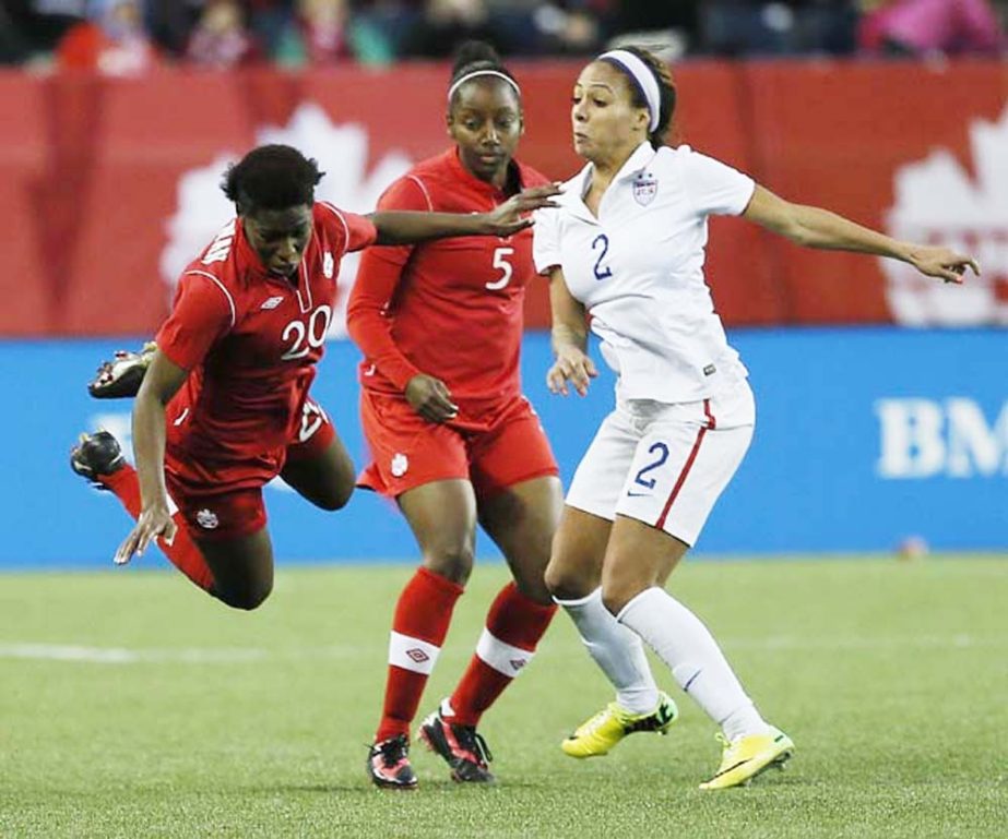 Canada's defender Robyn Gayle (5) looks on as Kadeisha Buchanan (20) is fouled by USA's forward Sydney Leroux (2) during second half soccer action during a friendly match in Winnipeg, Manitoba on Thursday.