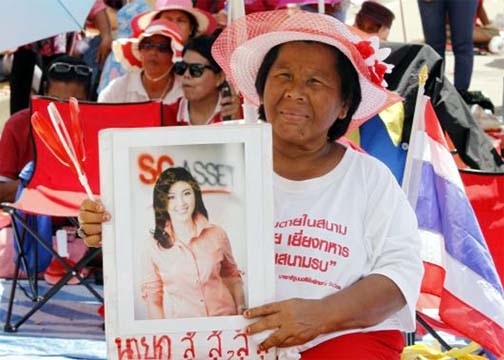 A member of the pro-government 'red shirt' group holds a picture of ousted Thai prime minister Yingluck Shinawatra during a rally in Nakhon Pathom province on the outskirts of Bangkok on Sunday.