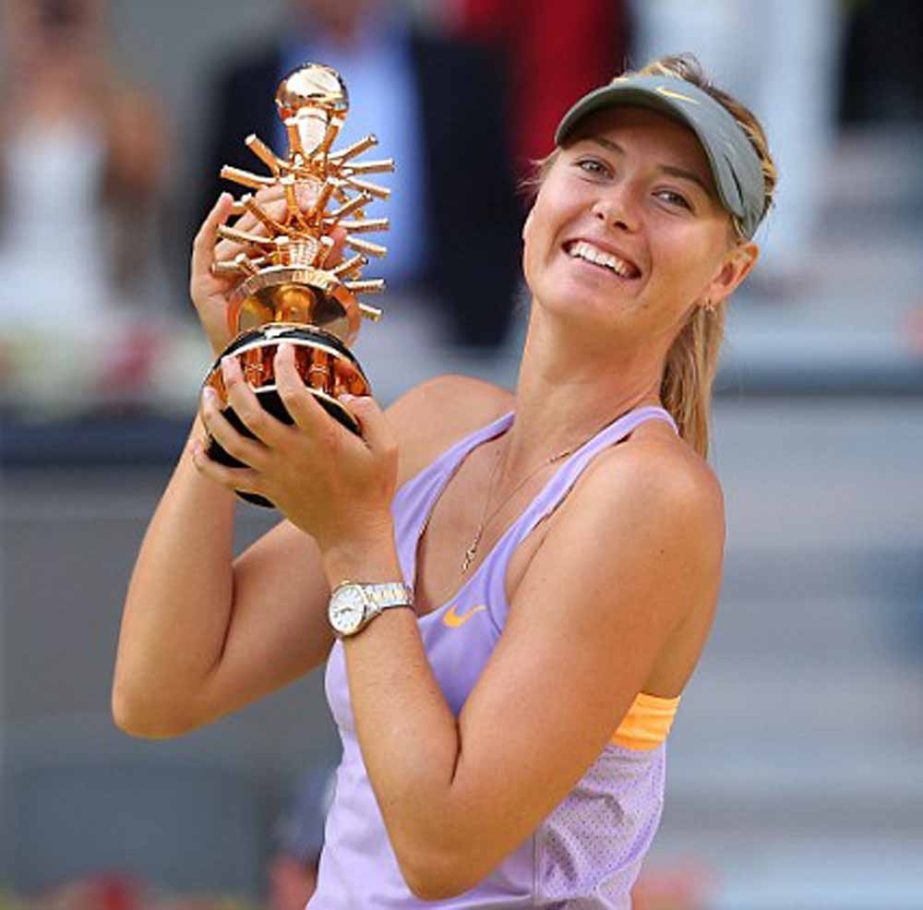 Maria Sharapova from Russia celebrates her victory holding her trophy during a Madrid Open tennis tournament final match against Simona Halep from Romania in Madrid, Spain on Sunday.