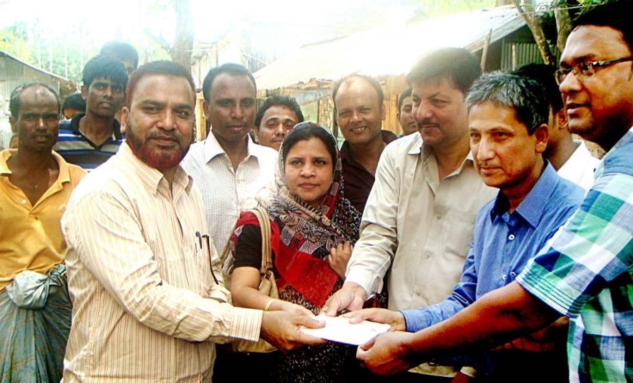 CDA Chairman Abdus Salam distributing cash money among the fire affected people of Bolirhat area in the city yesterday. The cash was donated by Mabia Rasidia Foundation.