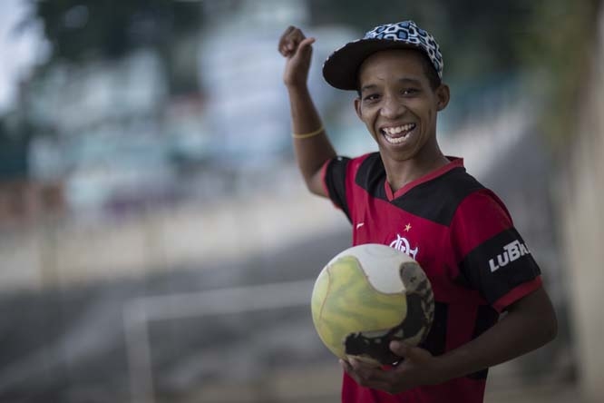 Kelvin, 15, poses for a photo before playing soccer at the Sao Carlos slum in Rio de Janeiro, Brazil on Monday. As opening day for the World Cup approaches people continue to stage protests, some about the billions of dollars spent on the World Cup at a