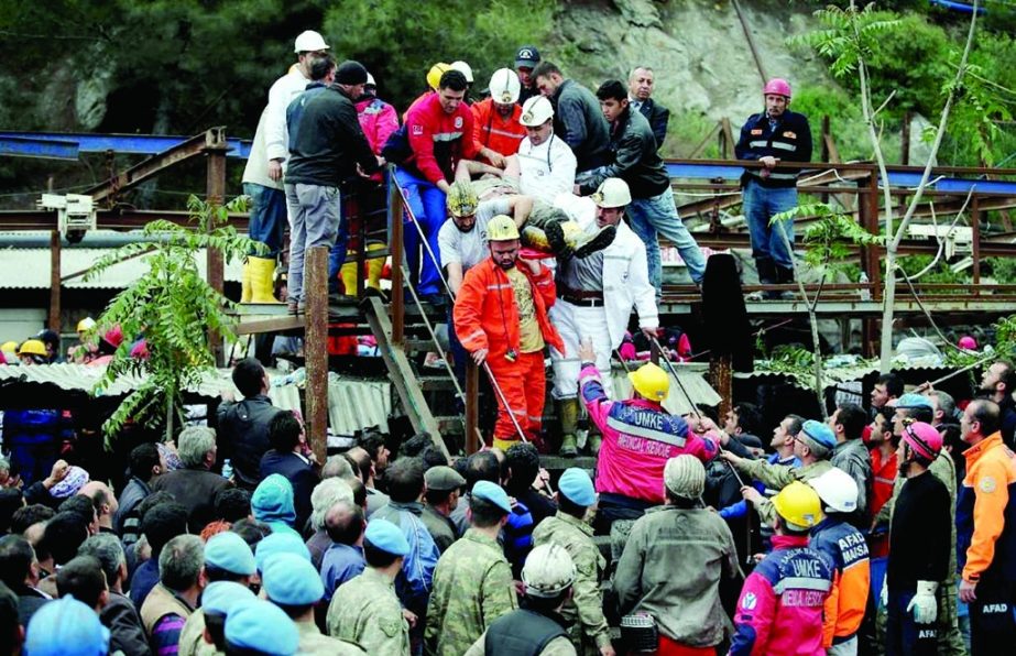 Rescue workers carry a rescued miner from the mine in Soma, western Turkey, early Wednesday. Rescuers desperately raced against time to reach more than 200 miners trapped underground after an explosion and fire at a coal mine in western Turkey killed at l