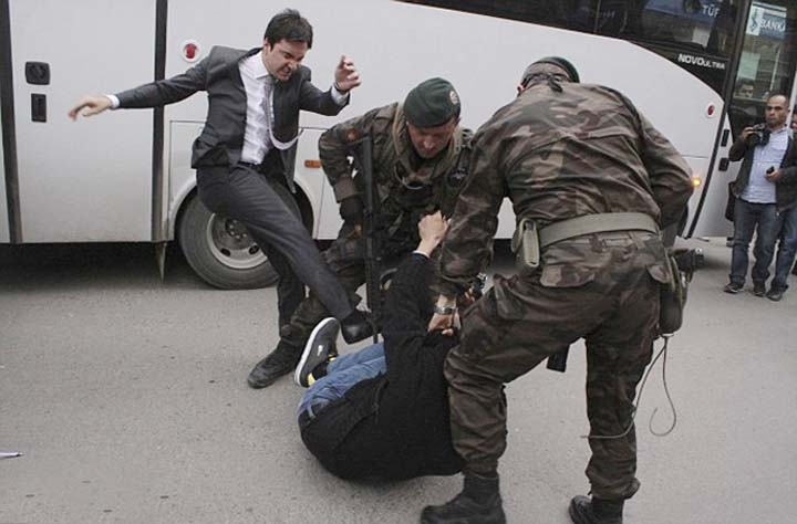 Adviser to Turkish prime minister Yusuf kicking a mourner of Soma mine disaster when protesters take to street on Thursday.