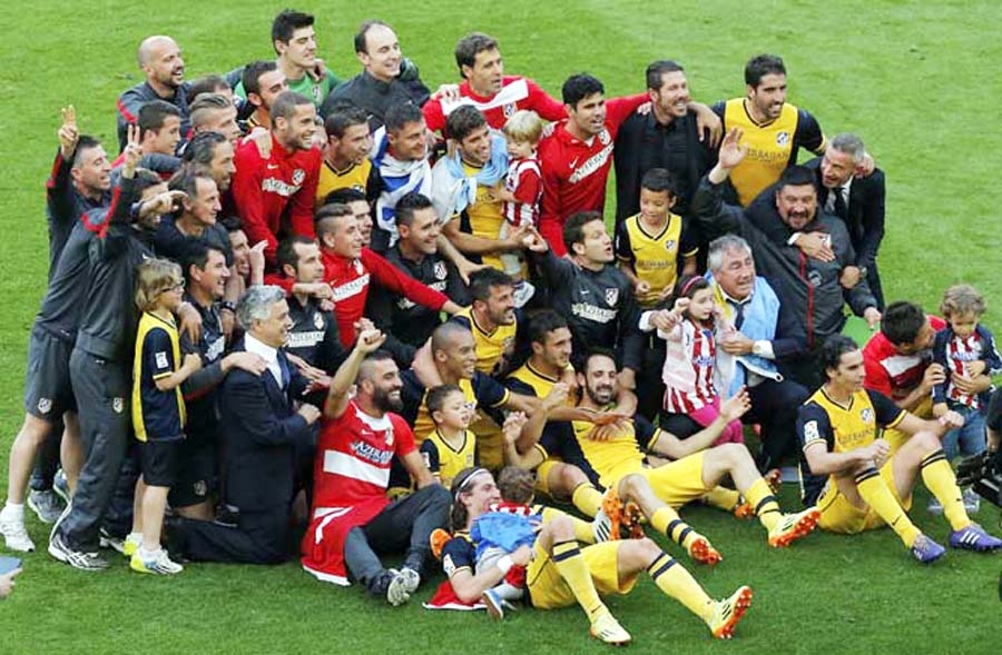 Atletico players celebrate after winning the Spanish League title during a Spanish La Liga soccer match between FC Barcelona and Atletico Madrid at the Camp Nou stadium in Barcelona, Spain on Saturday.