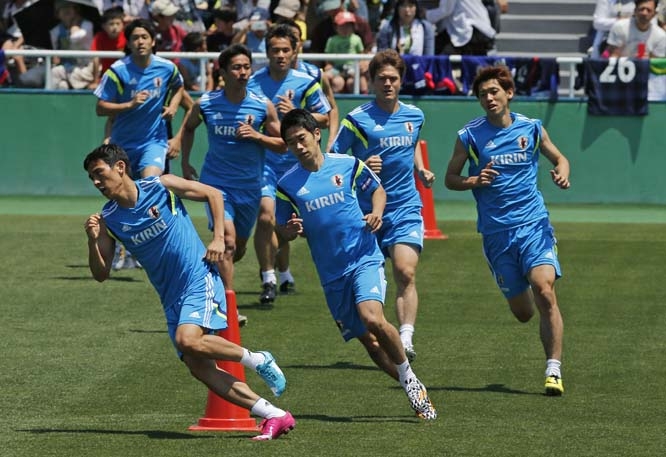 Shinji Kagawa (center) and Makoto Hasebe (left) lead their teammates during a training of Japan's national soccer team in Tokyo on Sunday. Japan is drawn in a Group C with Ivory Coast, Greece and Colombia at the World Cup in Brazil.