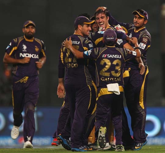 Pat Cummins is mobbed by his team-mates after striking in his first over during IPL 2014 match between Kolkata Knight Riders and Chennai Super Kings in Kolkata on Tuesday.