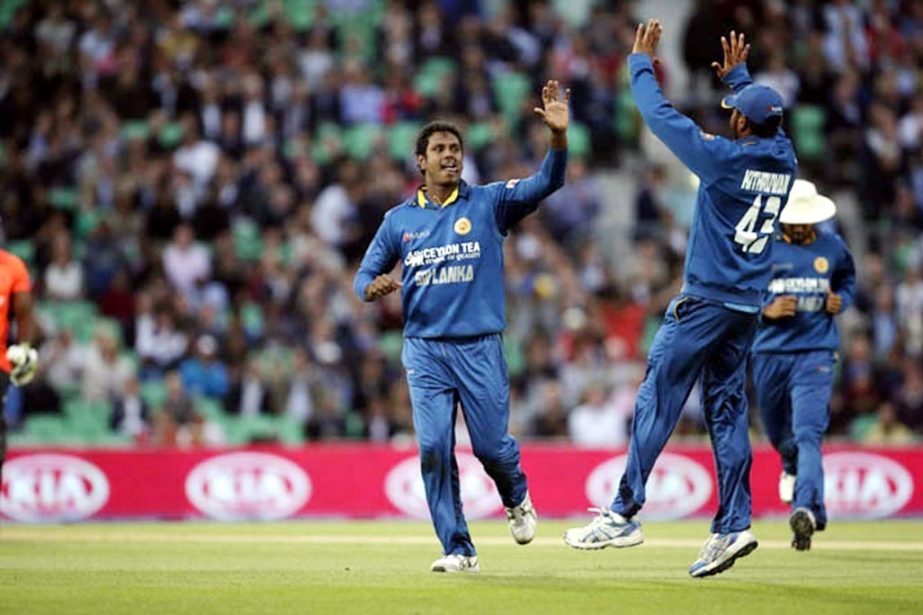 Sri Lanka's Angelo Mathews (left) celebrates after taking the wicket of England's Michael Carberry with his teammate Kithuruwan Vithanage (right) during the Twenty20 cricket match between England and Sri Lanka at the Oval cricket ground in London on Tue