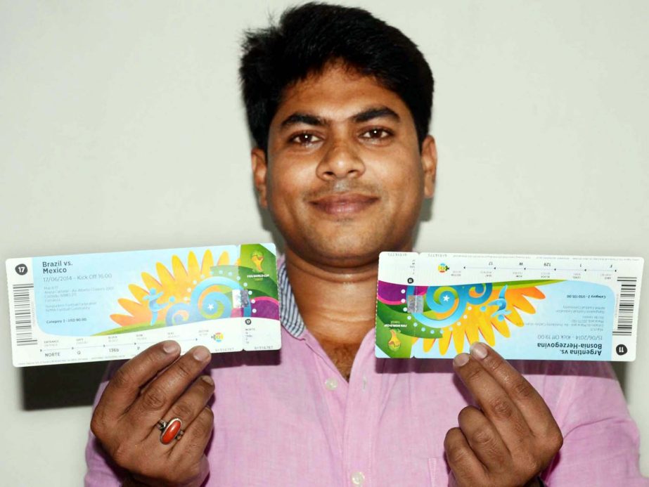 LUCKY FAN: Habibur Rahman Manik, a football lover of the country showing the tickets of the FIFA Brazil World Cup football in the city on Wednesday. Manik was delighted after getting the tickets of gala extravaganza.