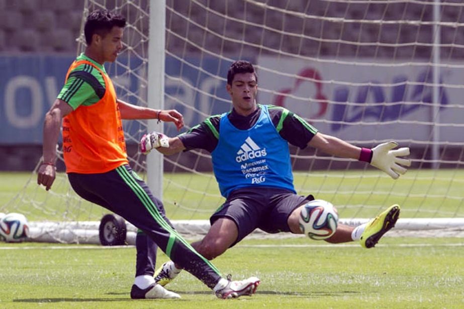 Mexico's Alfredo Talavera (left) fights for the ball with Raul Jimenez during a training session in Mexico City. Mexico will play the World Cup in Brazil in Group A with Brazil, Croatia and Cameroon on Wednesday.