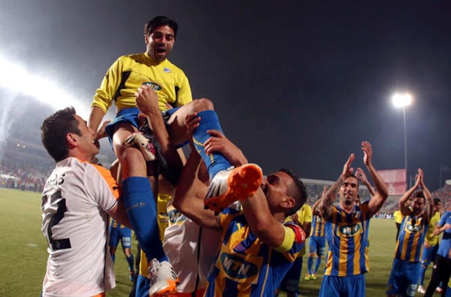 Players of APOEL Nicosia celebrate after their victory against Ermis after the Cyprus final soccer cup between APOEL and Ermis at GSP stadium in Nicosia, Cyprus on Wednesday.
