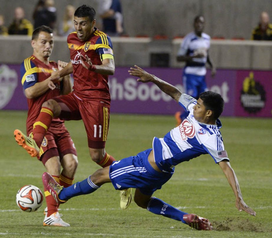 Real Salt Lake midfielder Javier Morales (11) goes for the ball along with FC Dallas defender Moises Hernandez (right) during an MLS soccer game in Sandy, Utah on Saturday. The game ended in a scoreless tie.