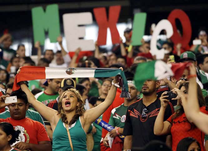 Mexico fans celebrate in the closing minutes of the second half of a friendly soccer match against Ecuador in Arlington, Texas on Saturday . Mexico won 3-1.