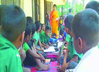 MOULVIBAZAR: A teacher of one of the risky schools building in Moulvibazar taking class at the outside of class room as cracks have developed in the building . This picture was taken on Saturday.