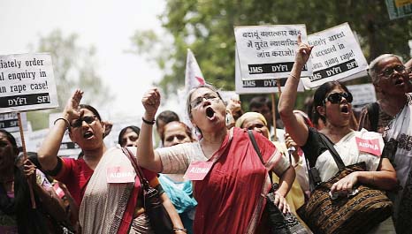 Demonstrators from All India Democratic Women's Association (AIDWA) hold placards and shout slogans during a protest against the recent killings of two teenage girls, in New Delhi.