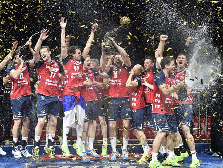 The handball team of SG Flensburg-Handewitt celebrates with the trophy and champagne after winning the Final Four Champions League final against THW Kiel in Cologne, Germany on Sunday. Flensburg defeated Kiel with 30-28.
