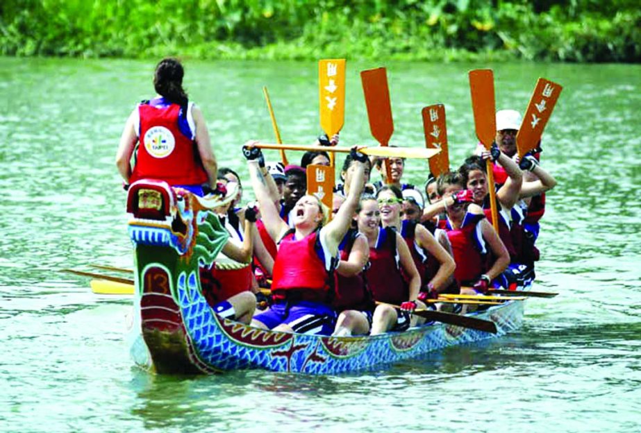 Chinese language students react to winning a traditional Chinese Dragon Boat race in Taipei, Taiwan on Monday. Dragon boat races are in remembrance of Chu Yuan, an ancient Chinese scholar-statesman, who drowned in 277 B.C. while denouncing government corr