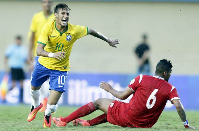 Brazil's Neymar (left) is fouled by Panama's Gabriel Gomez during a friendly soccer match at the Serra Dourada stadium in Goiania, Brazil on Tuesday. Brazil won the match 4-0. Brazil are preparing for the World Cup soccer tournament that starts on June