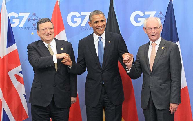 European Commission President Jose Manuel Barroso, left, and European Council President Herman Van Rompuy, right, welcome US President Barack Obama at the G7 meeting at the European Council building in Brussels on Wednesday.