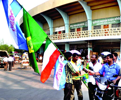 Flags of different participating countries in World Cup Football are on sale in the city ahead of the mega festival. This photo was taken from Stadium area in the city on Thursday. Moin Ahmed