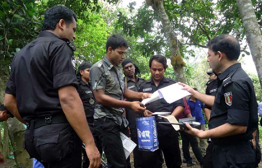 RAB searching a suspected youth at Satchari National Park in Chittagong yesterday.