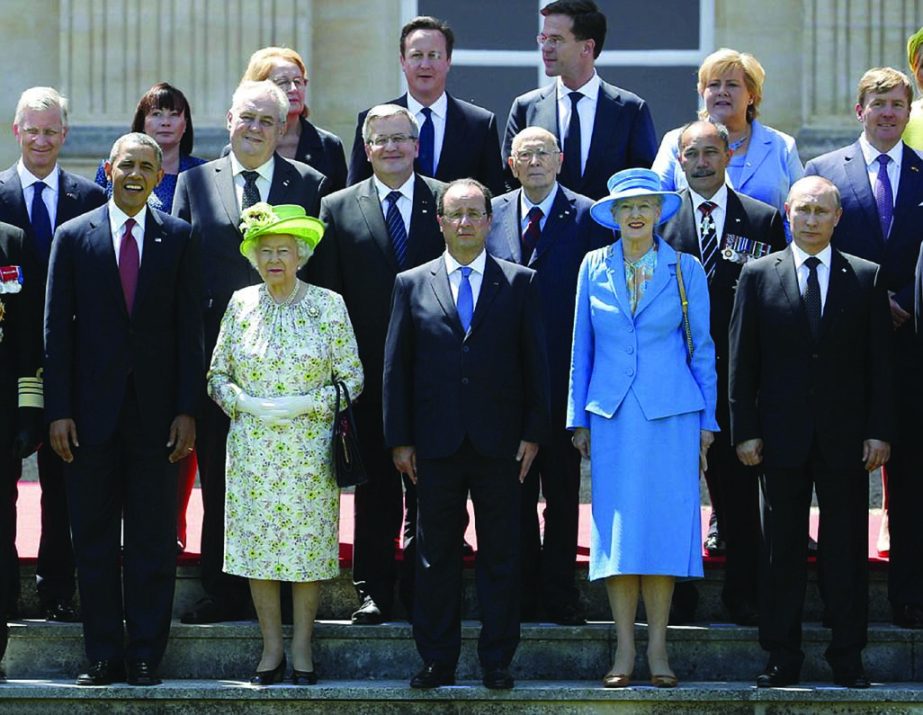 International pose: President Barack Obama (front left) and French President Francois Hollande (middle) stand with The Queen (second left) and Russian President Vladimir Putin (front right) and David Cameron (back left) for a photo outside the Chateau Ben