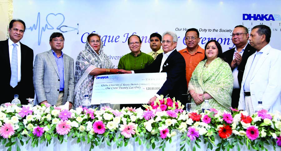 Abdul Hai Sarker, Chairman of Dhaka Bank handing over a cheque of Tk1.2 crore to Ferdousi Ali, Chairperson of Khulna University and Rotary District Community Hospital under its CSR initiatives on Wednesday. Bangladesh Bank Governor Dr Atiur Rahman was pre