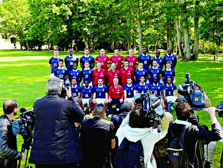 Reporters gather to take photos and footage of France's national football team players pose for a group photo at the French national football team's training base in Clairefontaine-en-Yvelines, outside Paris, on June 6, 2014, during France's national f