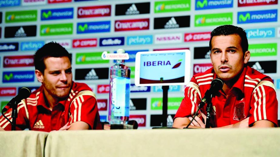 Cesar Azpilicueta (L) and Pedro Rodriguez of Spain face the media during a press conference of the Spain National team at the Mandarin Hotel in Washington DC on Thursday.