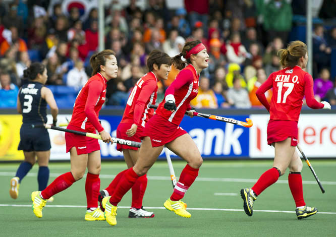 Korea's captain Jongeun Kim (center) celebrates her goal with her teammates, during the Field Hockey World Cup match against Japan in The Hague, Netherlands on Thursday.