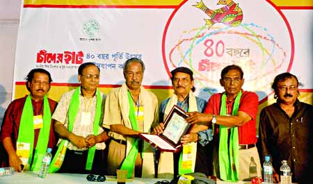 Journalist Zakaria Pintu and Rafiqul Haque giving citation crest to Editor of the daily New Nation AM Mufazzal in observance of 40th founding anniversary of Chander Haat, a national juvenile and youth welfare organization at the National Press Club on Fri