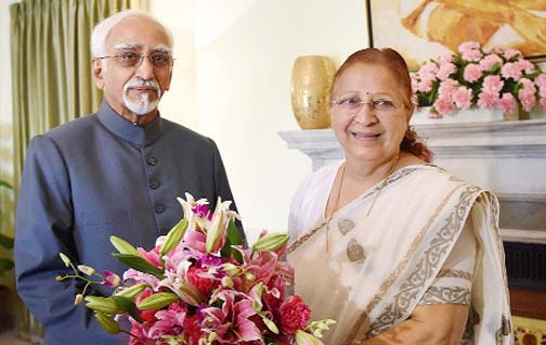 Lok Sabha Speaker Sumitra Mahajan presents a bouquet to Vice President Hamid Ansari at a meeting in New Delhi.