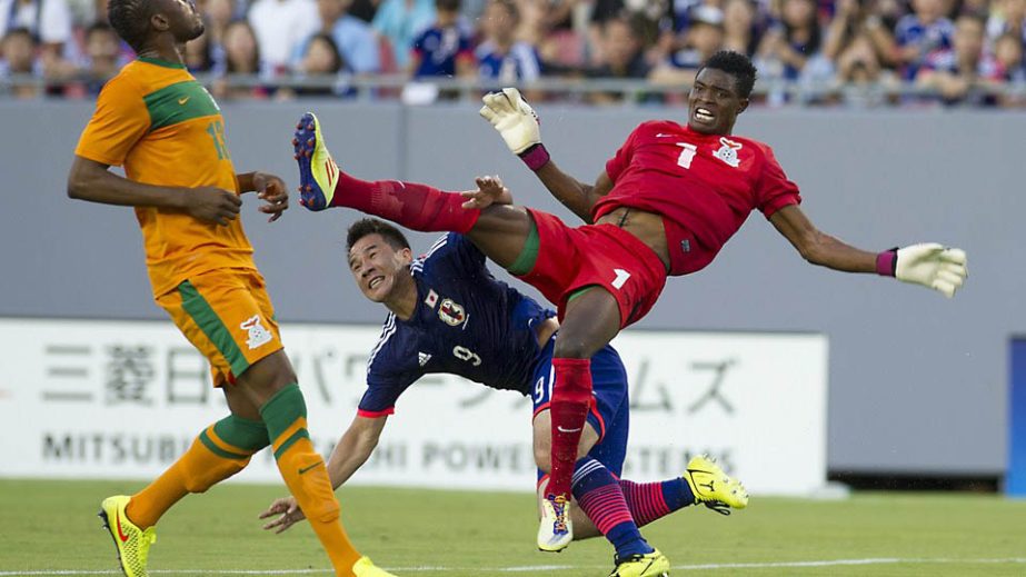 Japan's Shinji Okazaki (C) collides with Zambian goalkeeper Toaster Nsabata (R) during the friendly match between Japan and Zambia played at Raymond James Stadium in Tampa Bay, Florida on Friday. AFP photo