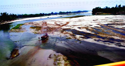 The vast areas of once mighty Atrai River, now occupied by the unscrupulous sand traders have become virtual desert. A truck is seen plying deep inside the dried portion of the river to collect sands illegally. This photo was taken from Kantajeur Mandir o