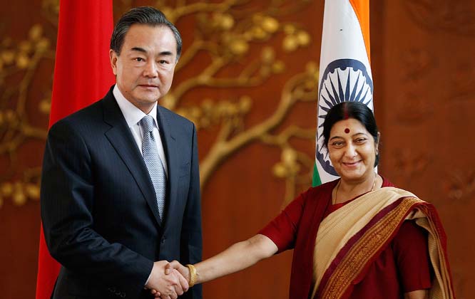 Indian External Affairs Minister Sushma Swaraj, shakes hands with her Chinese counterpart, Wang Yi, before their meeting in New Delhi..